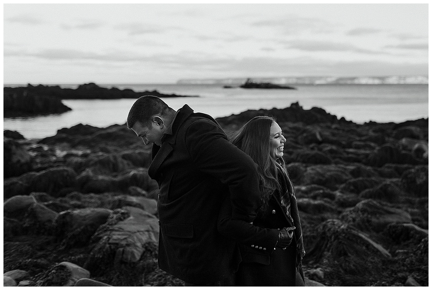 couple laughing during engagement photos in Lubec, Maine