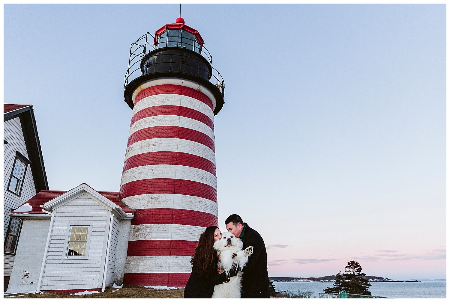 couple with their dog in front of Quoddy Head Light