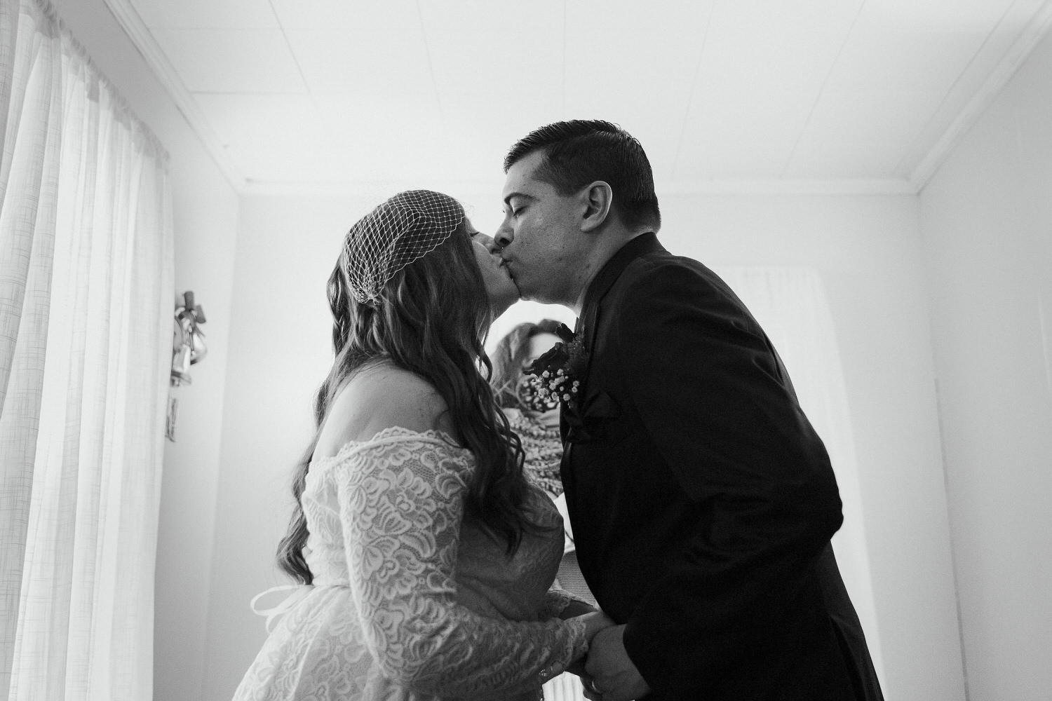 first kiss at winter wedding in Millinocket Maine
