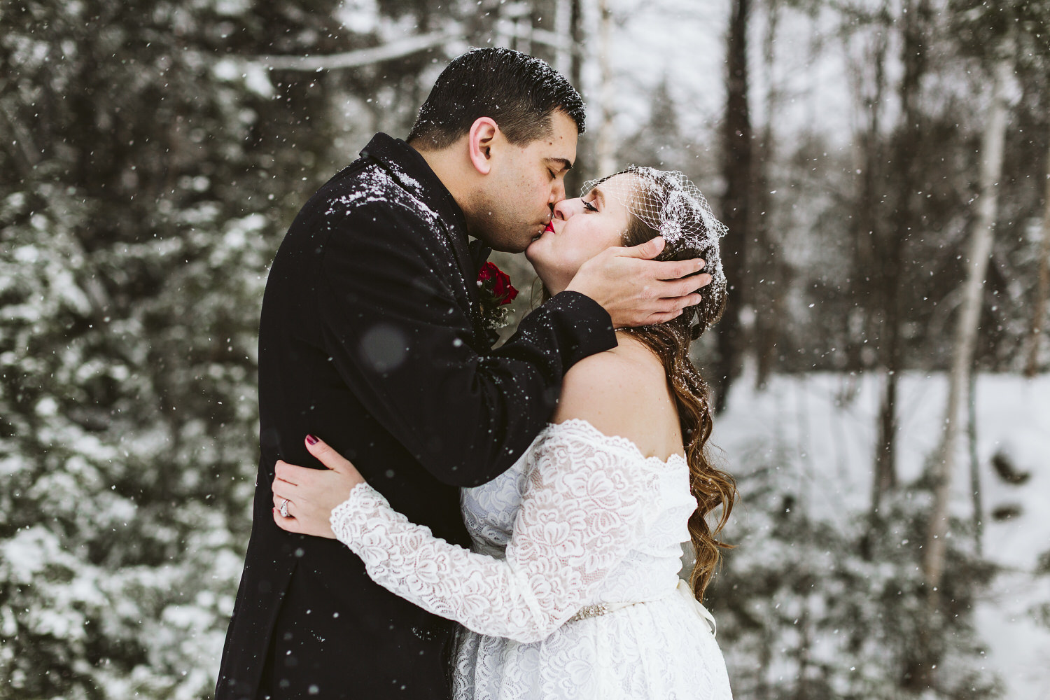 bride and groom kissing at winter wedding in Millinocket Maine