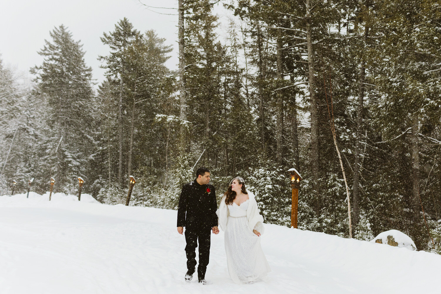 Maine bride and groom walking in the snow