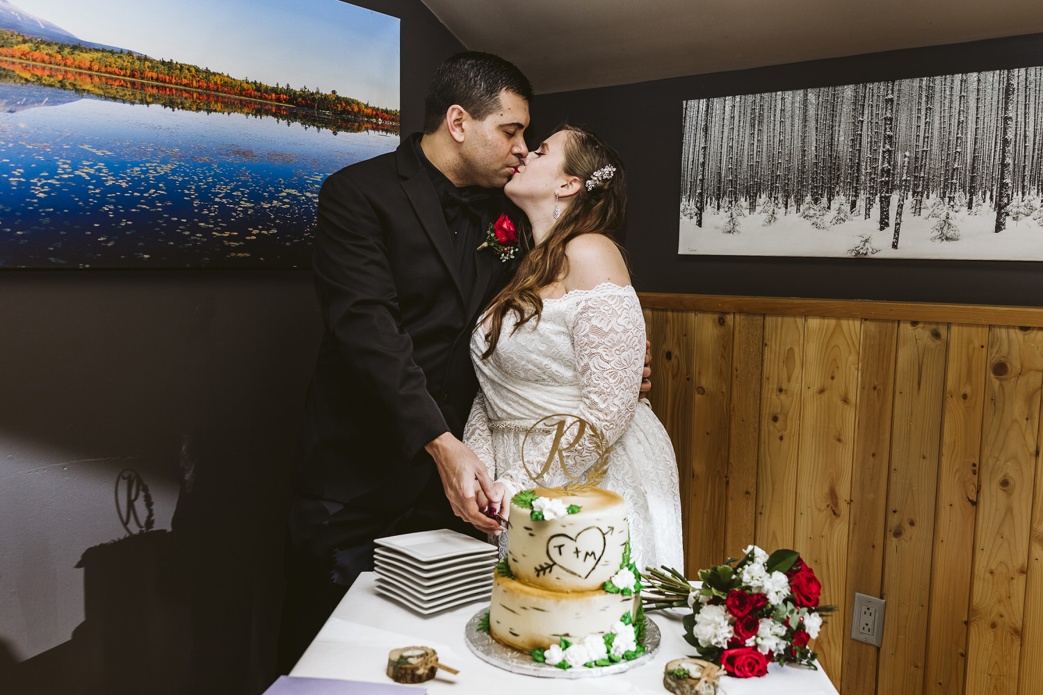 bride and groom kissing during their Millinocket Maine reception at NEOC