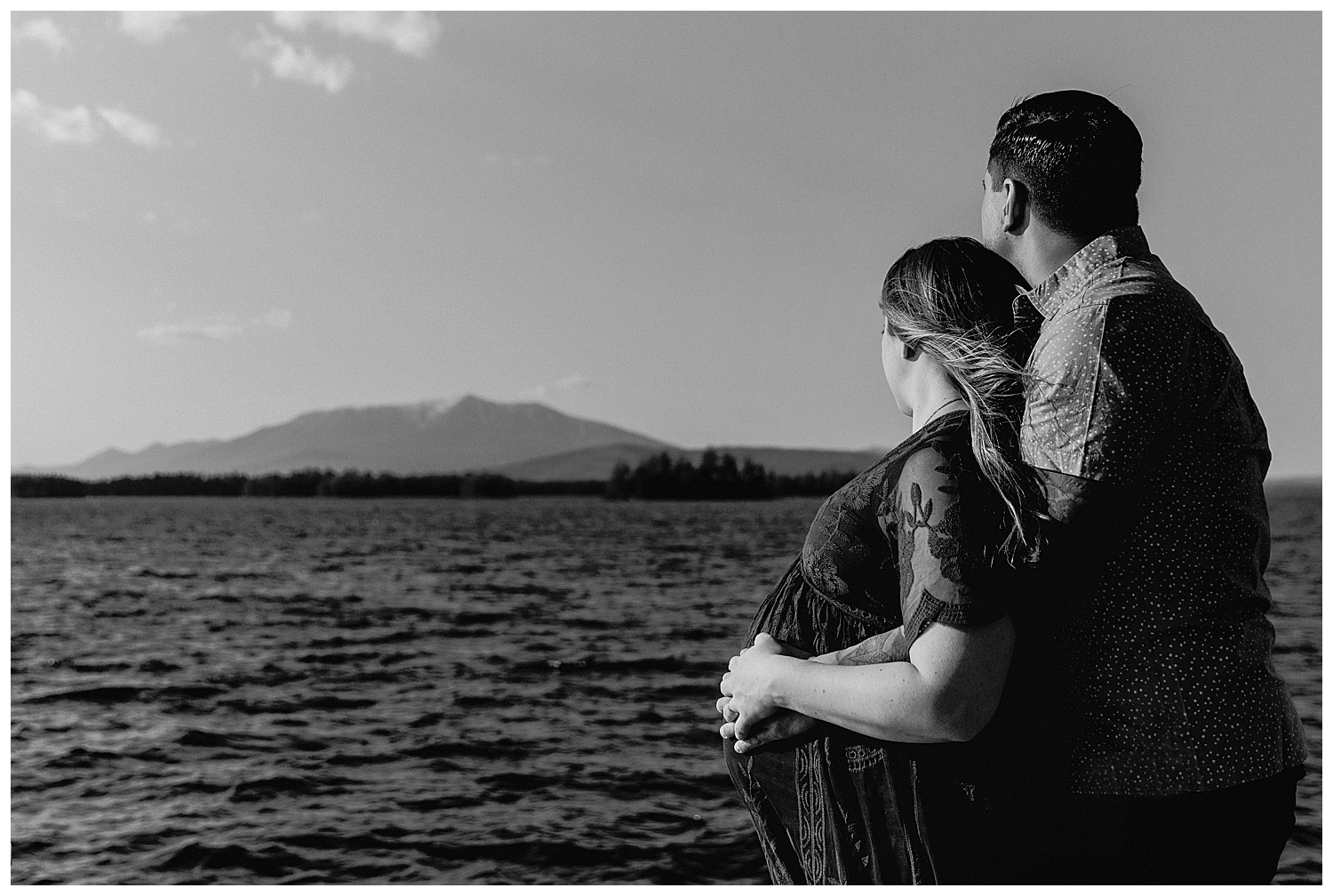 couple standing in front of Mount Katahdin during maternity photos