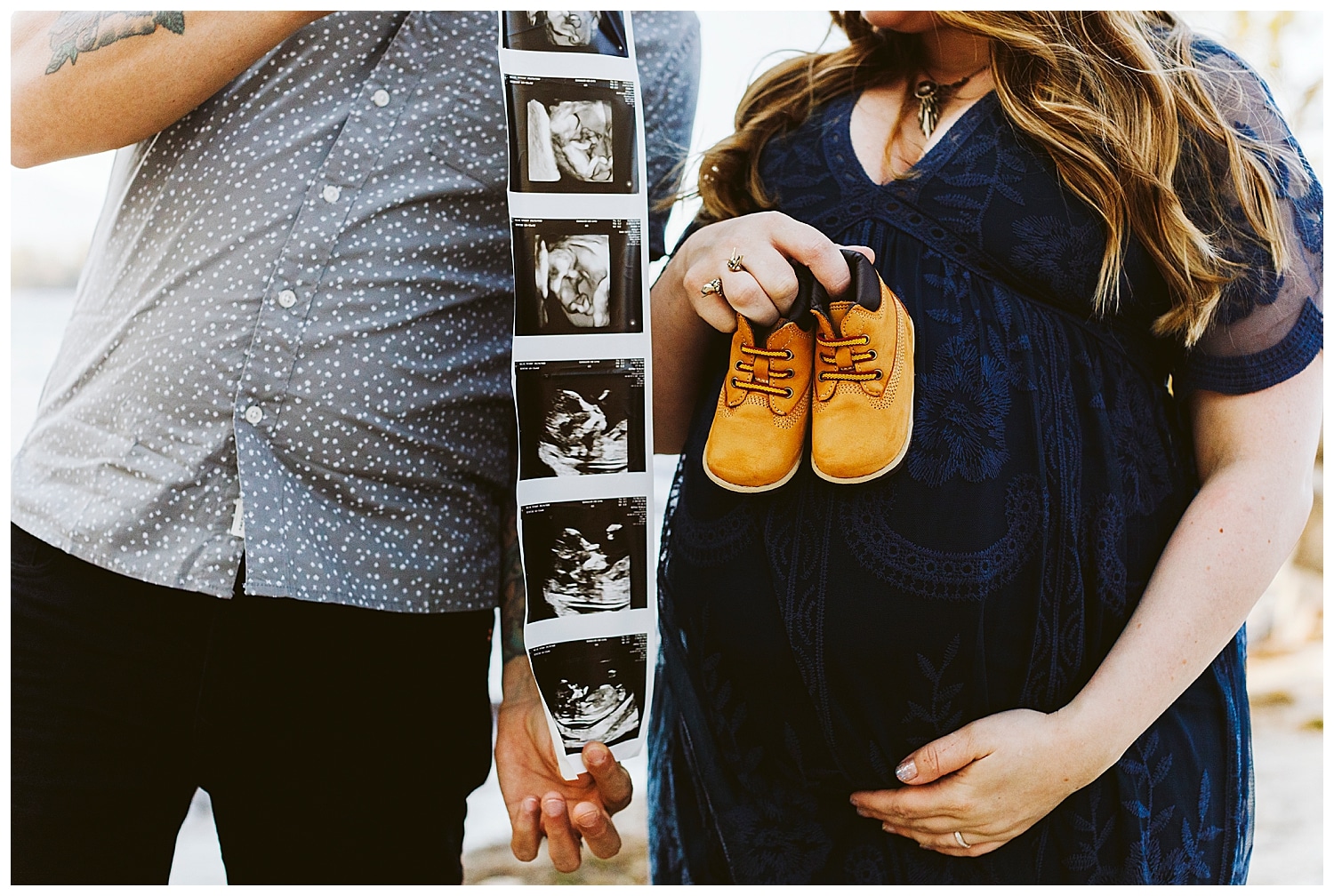 couple holding ultrasound and baby shoes
