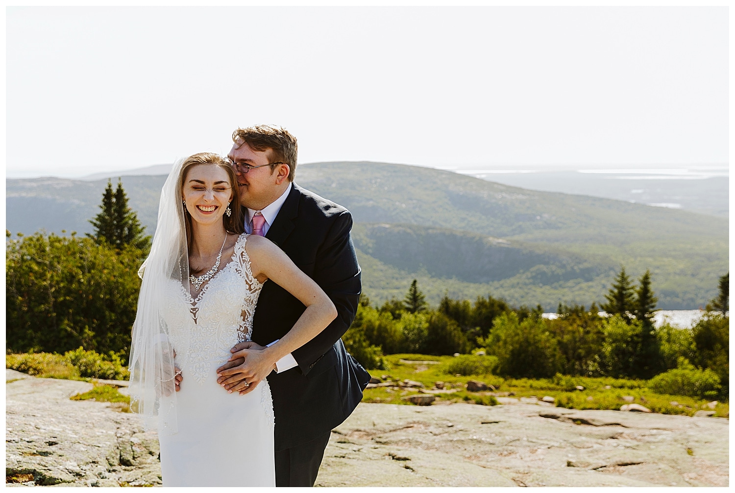 Bride and groom laughing together in Acadia National Park