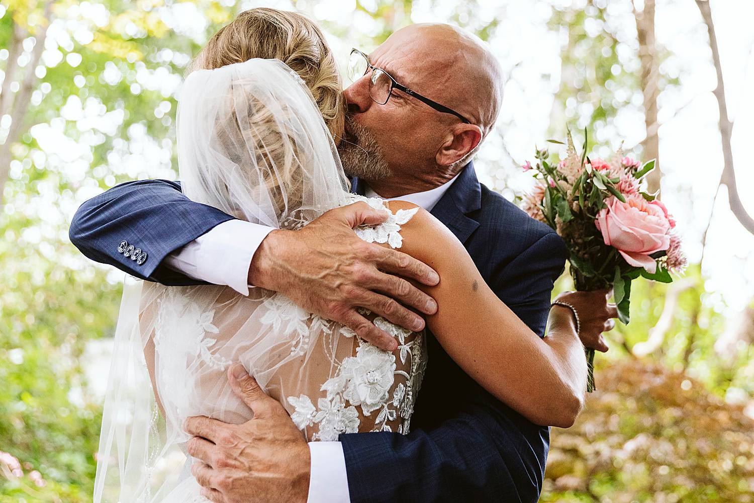 father of the bride kissing her head
