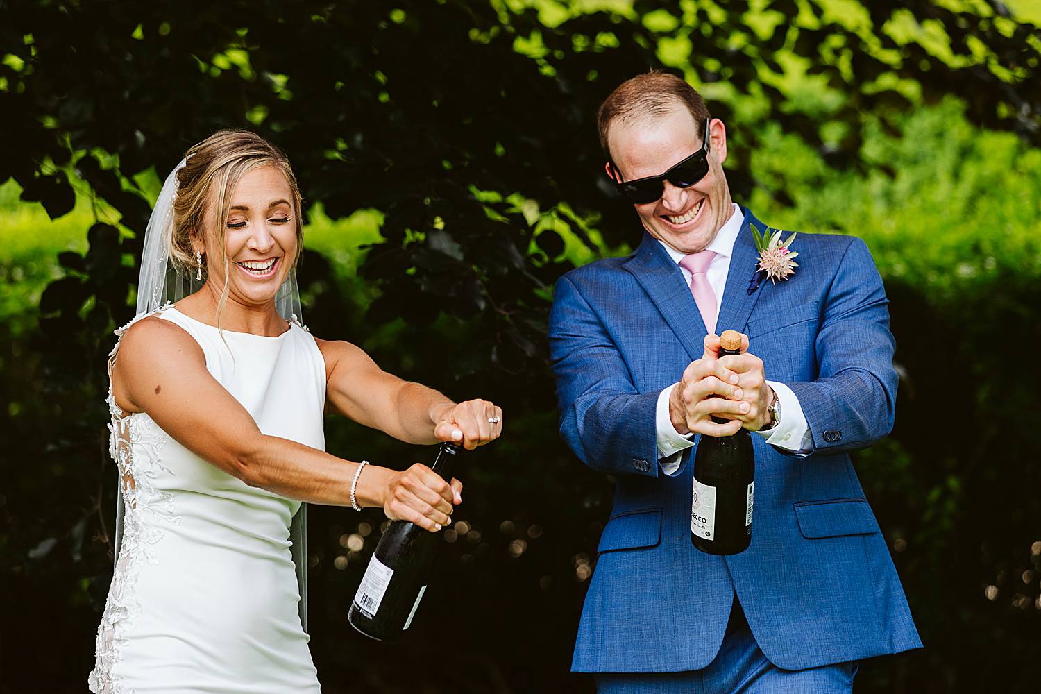 Bride and groom popping champagne at North Hampton, NH wedding at fuller gardens