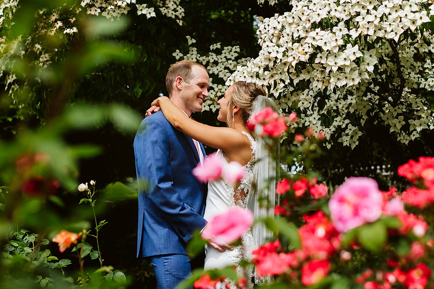 Bride and groom with flowers at Fuller Gardens