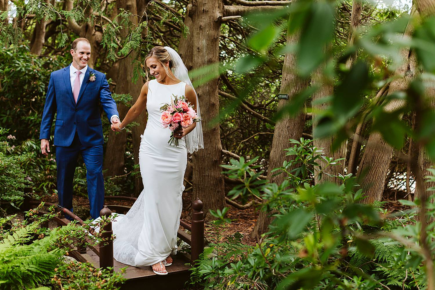 Bride and groom walking and holding hands at North Hampton, NH wedding at Fuller Gardens
