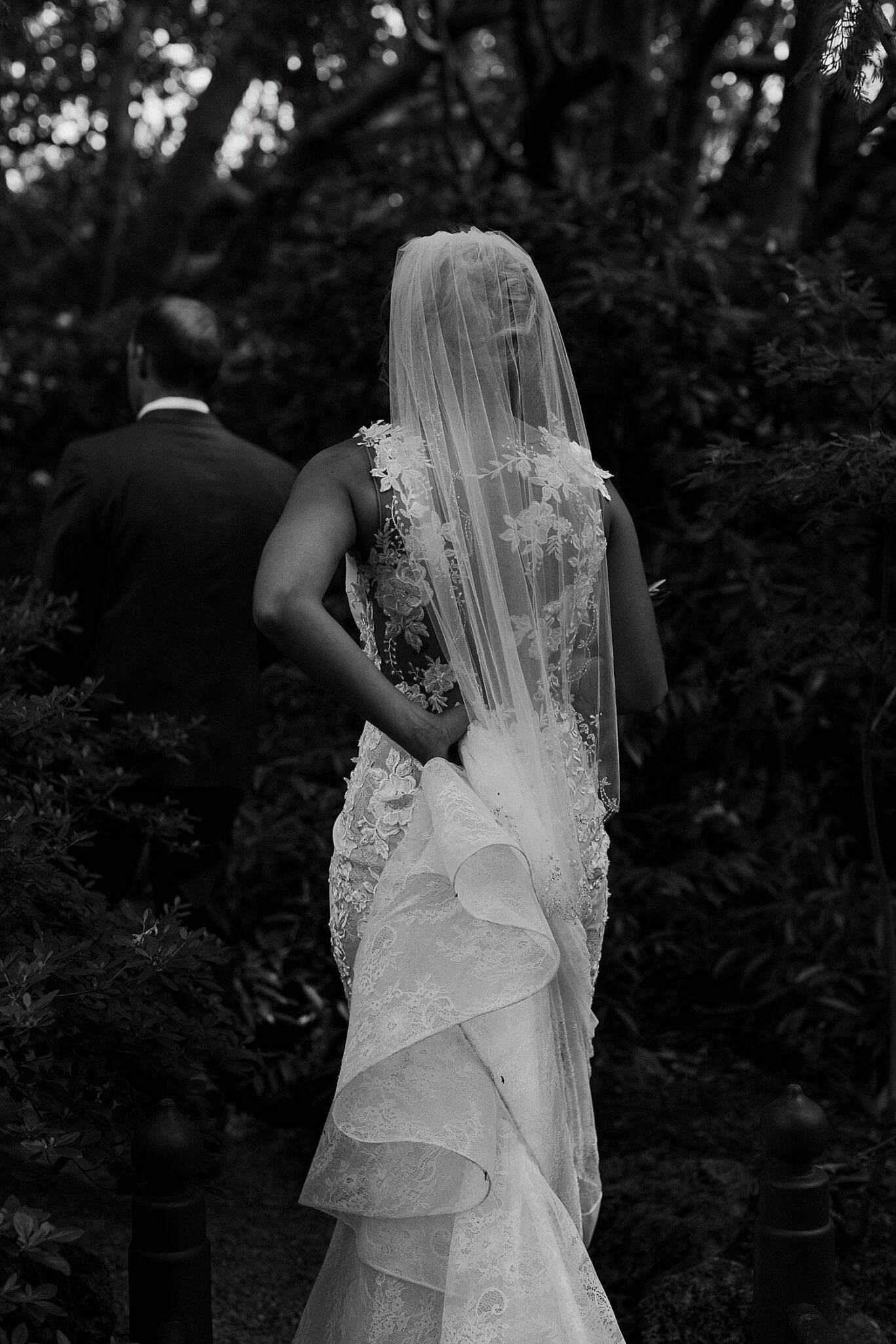 bride and groom walking together through japanese garden