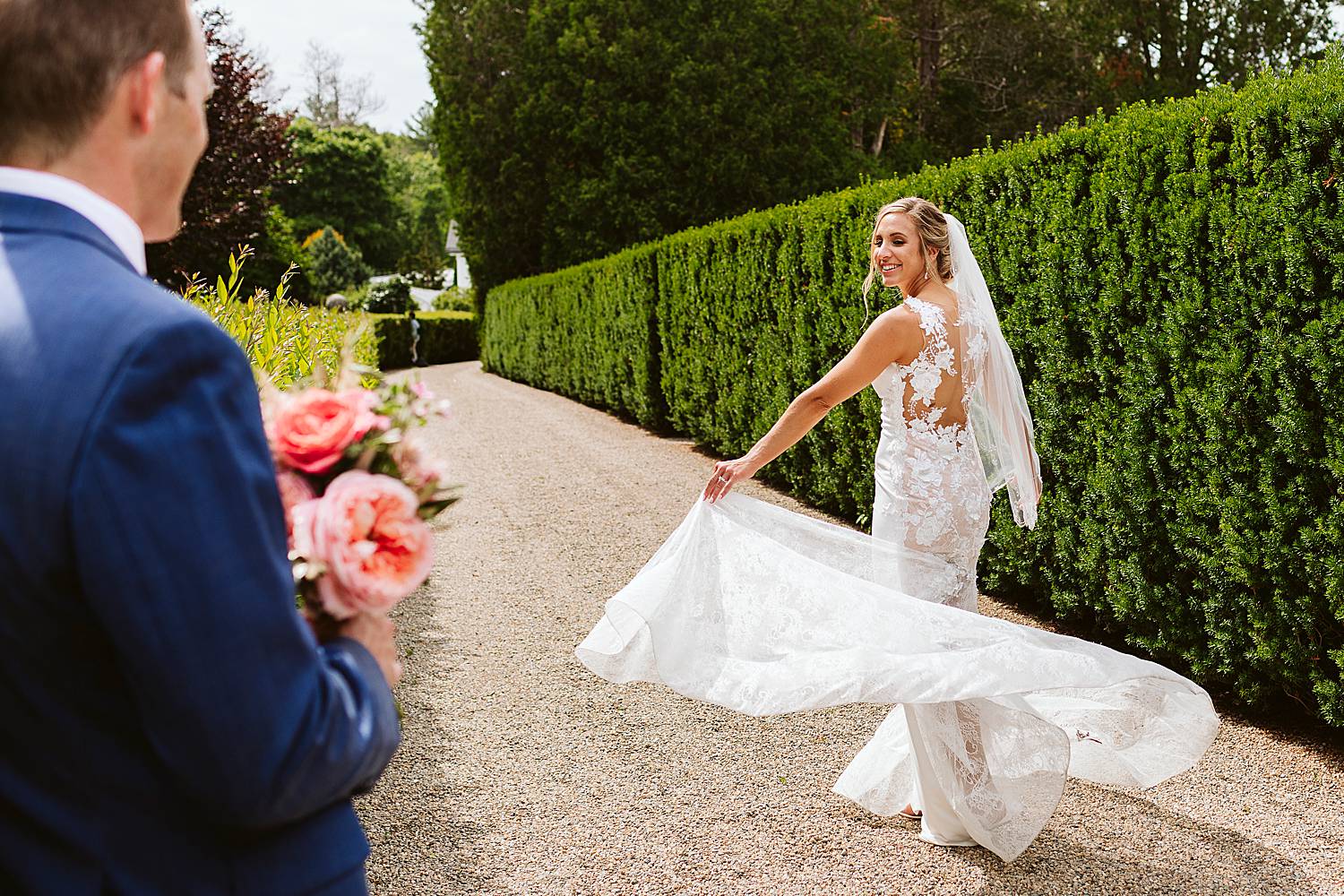 bride twirling her dress while the groom looks on at North Hampton, NH wedding at fuller gardens