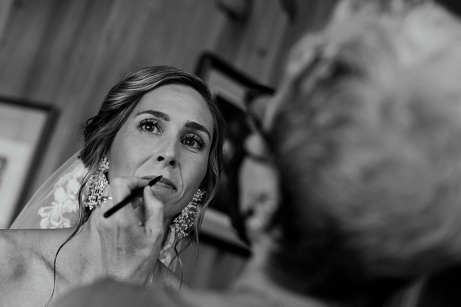 bride's makeup being touched up