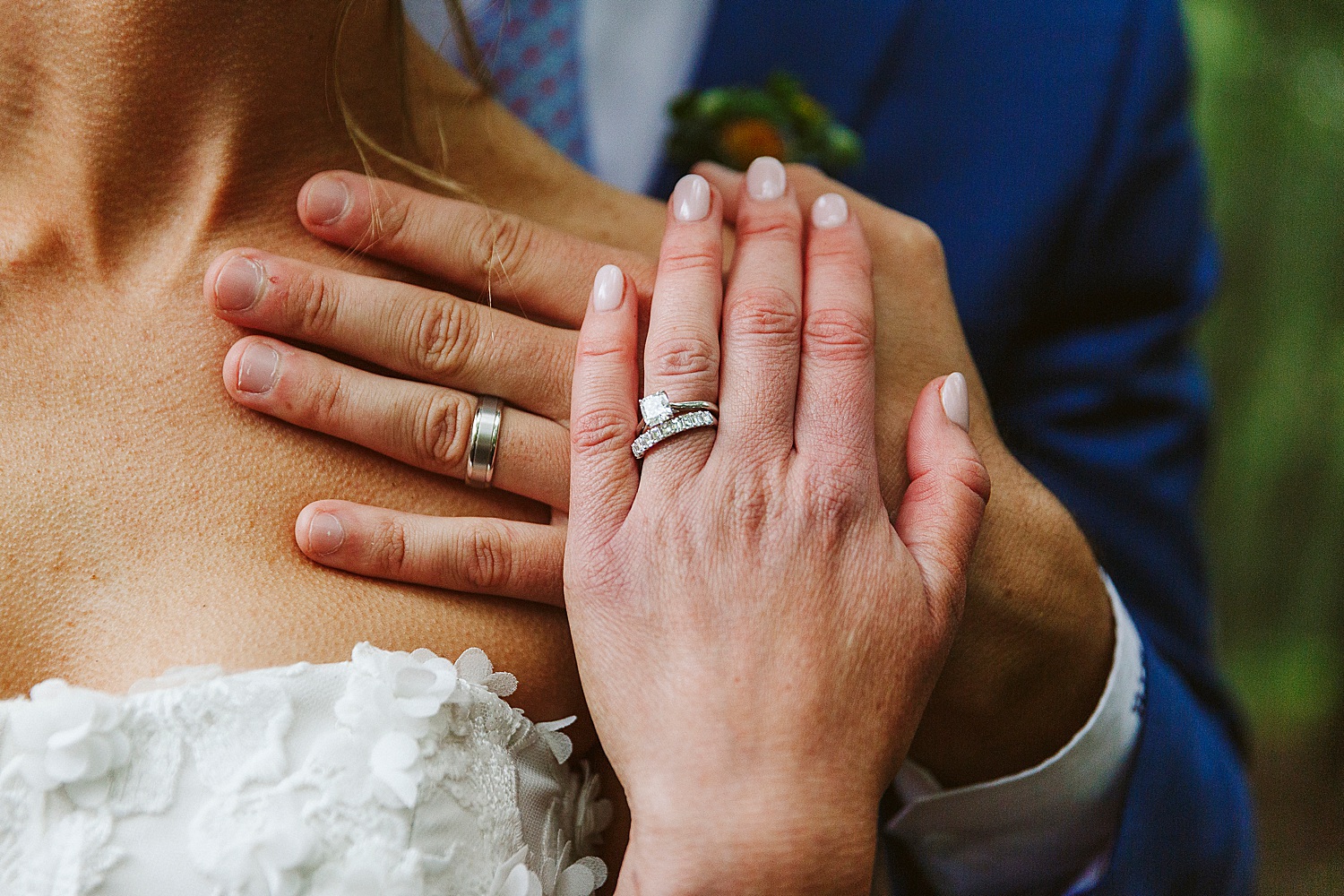 bride and groom's wedding rings on their hands