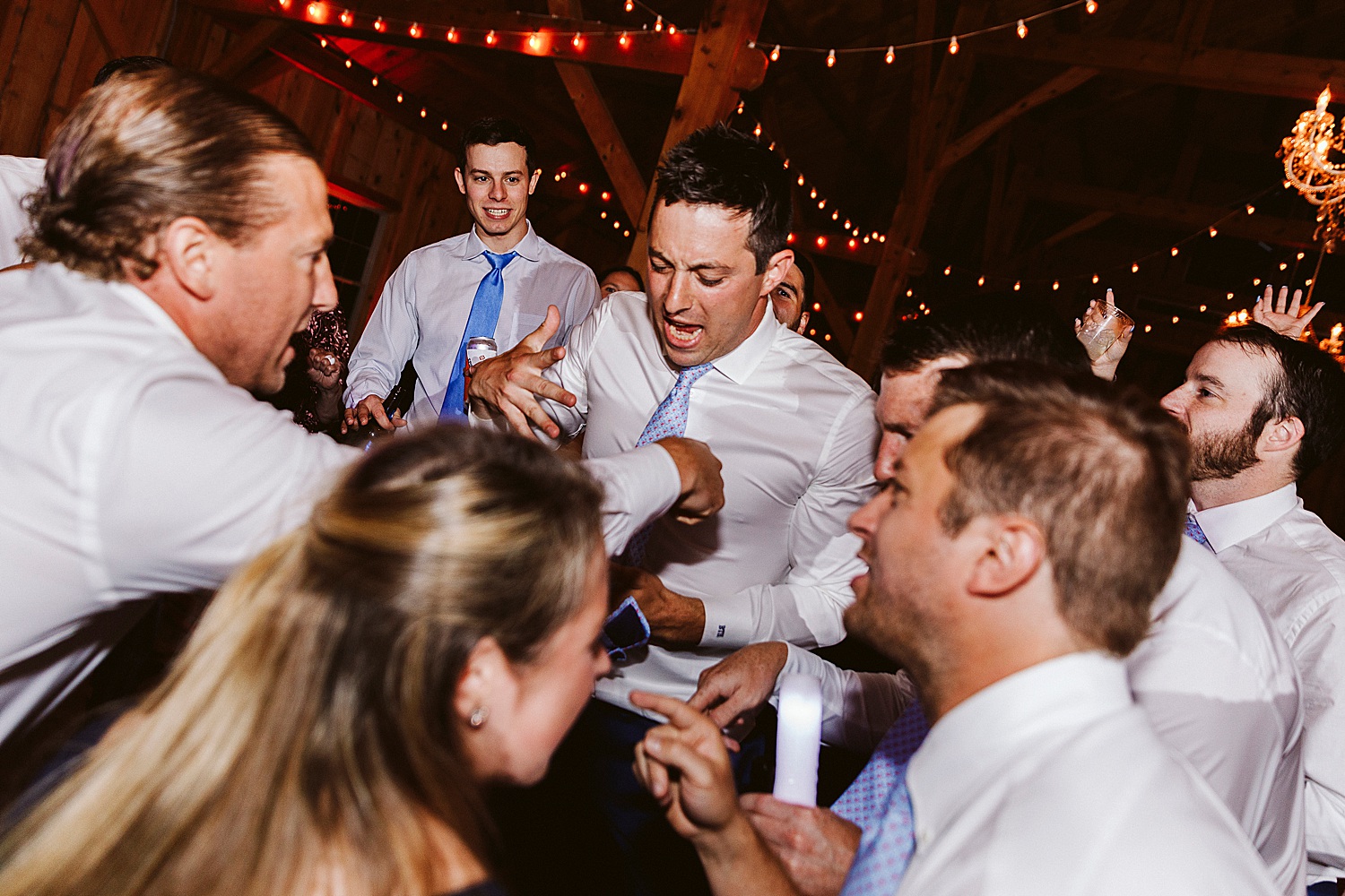 groom surrounded by friends on dance floor at Maine wedding