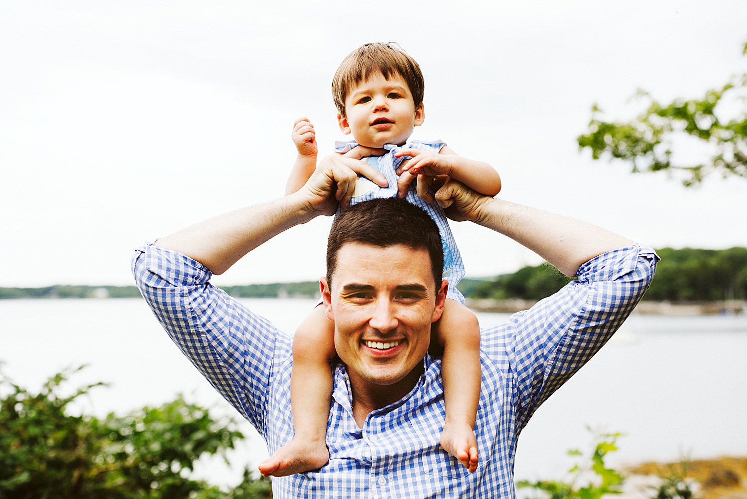 father with son on his shoulders during summer portraits in Sargentville, Maine