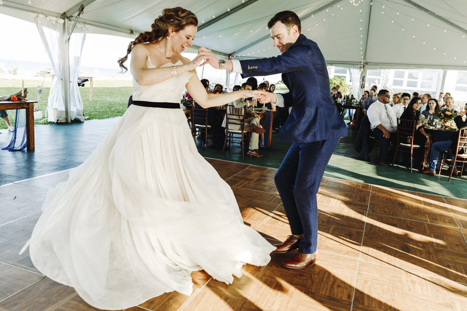 groom spins bride on the dance floor at wedding at Seacoast Science Center