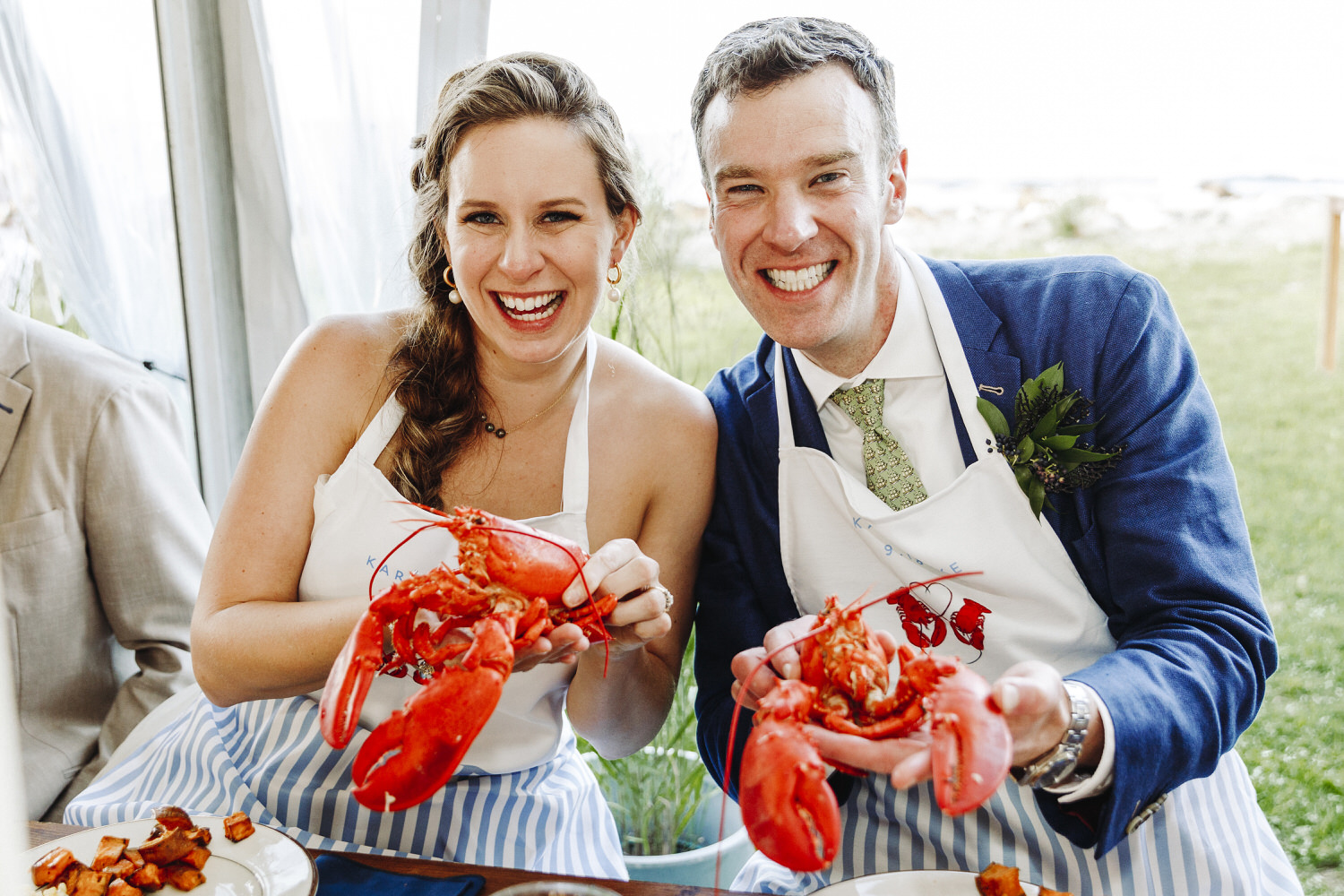 bride and groom holding lobster at Seacoast Science Center wedding