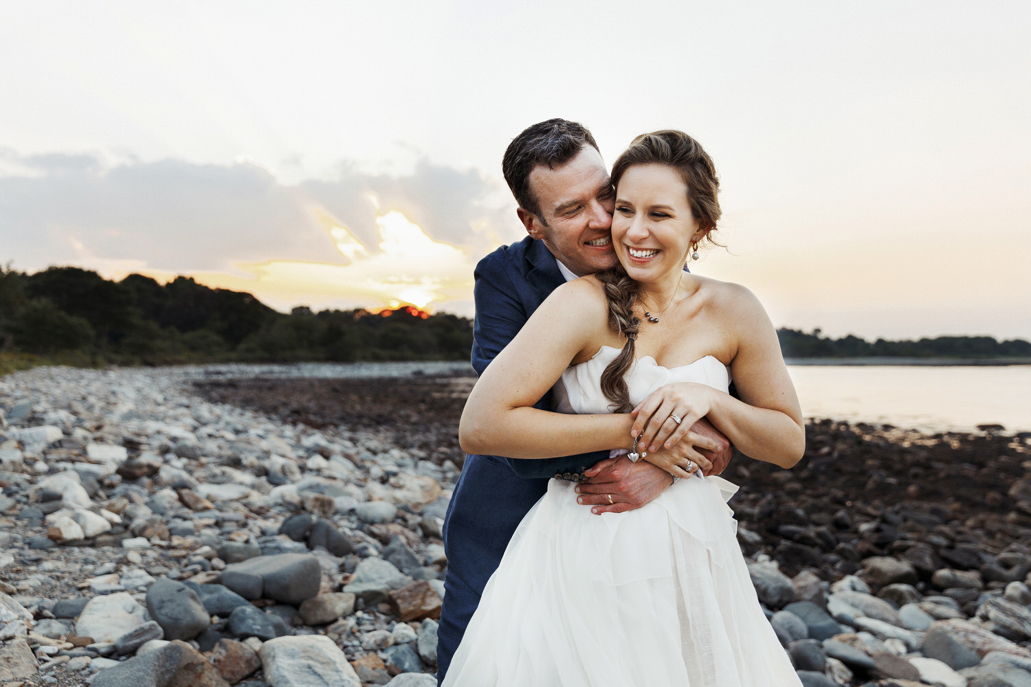 bride and groom cuddling at sunset during wedding at Seacoast Science Center