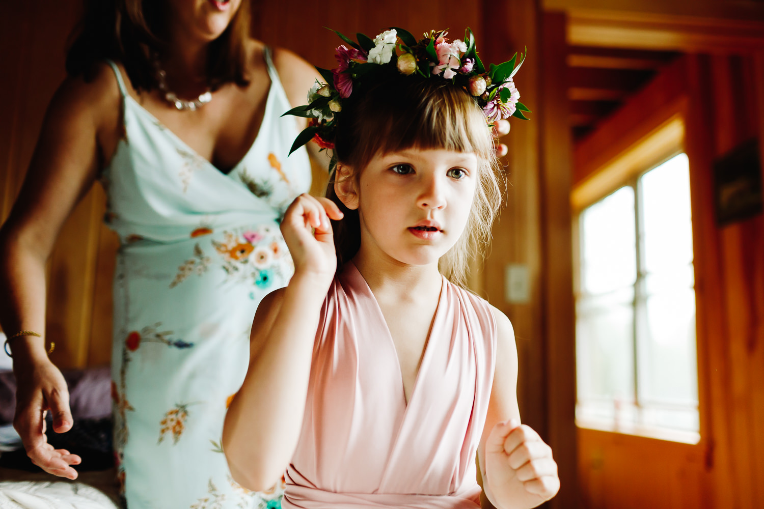 flower girl getting ready at backyard wedding in Northport, Maine