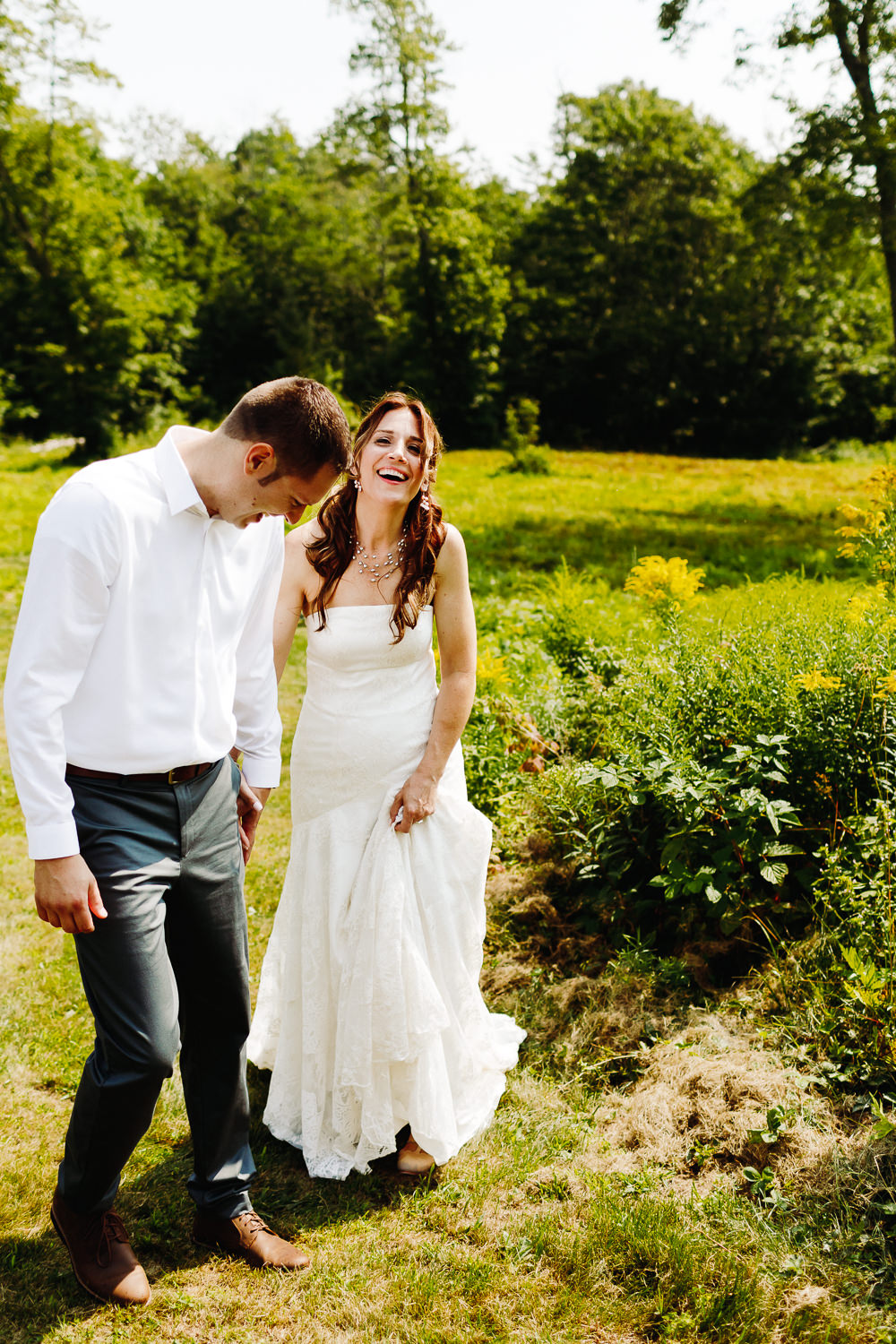 bride and groom laughing together at backyard wedding in Northport, Maine