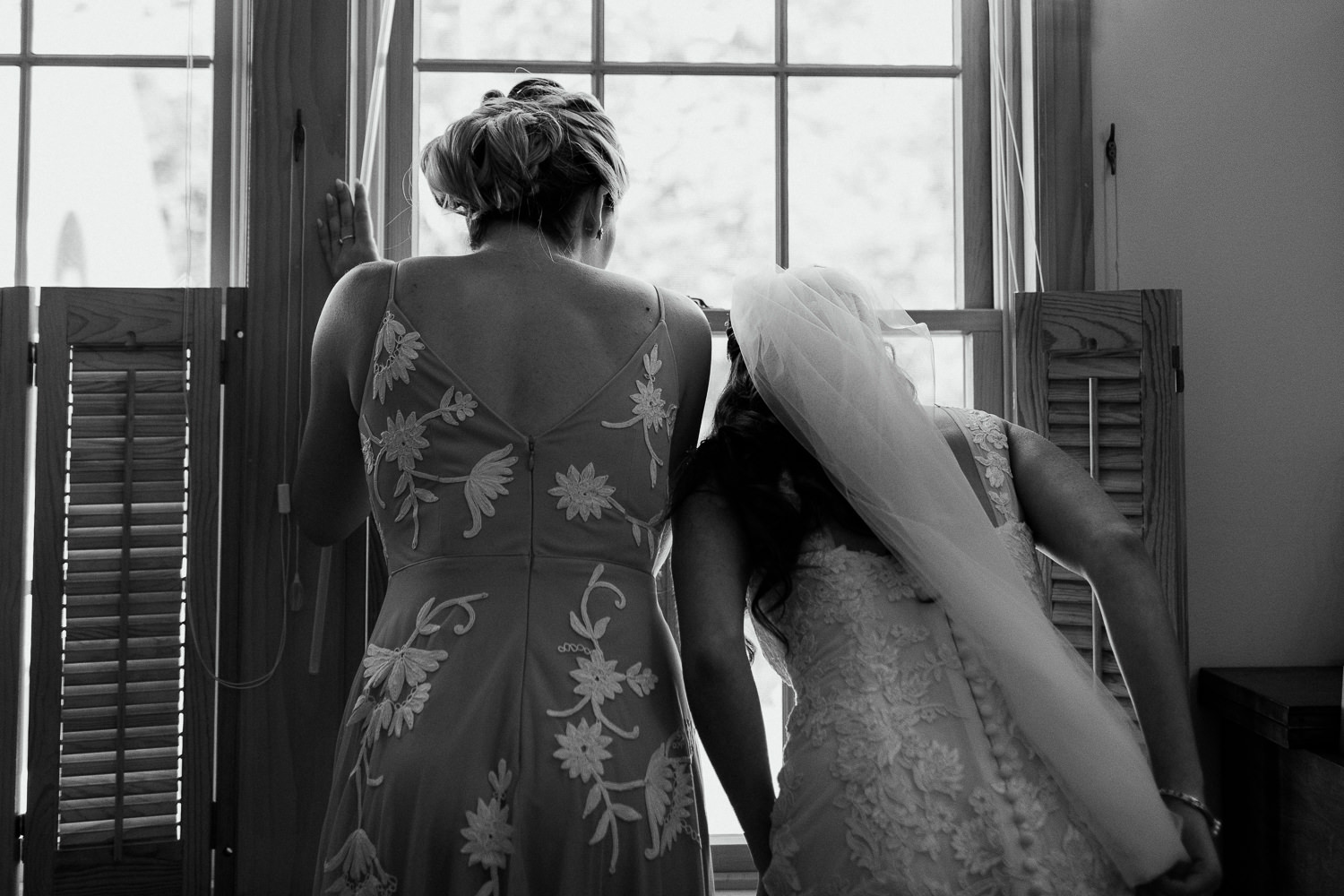 bride peeking out window before ceremony at Arlington, Vermont wedding
