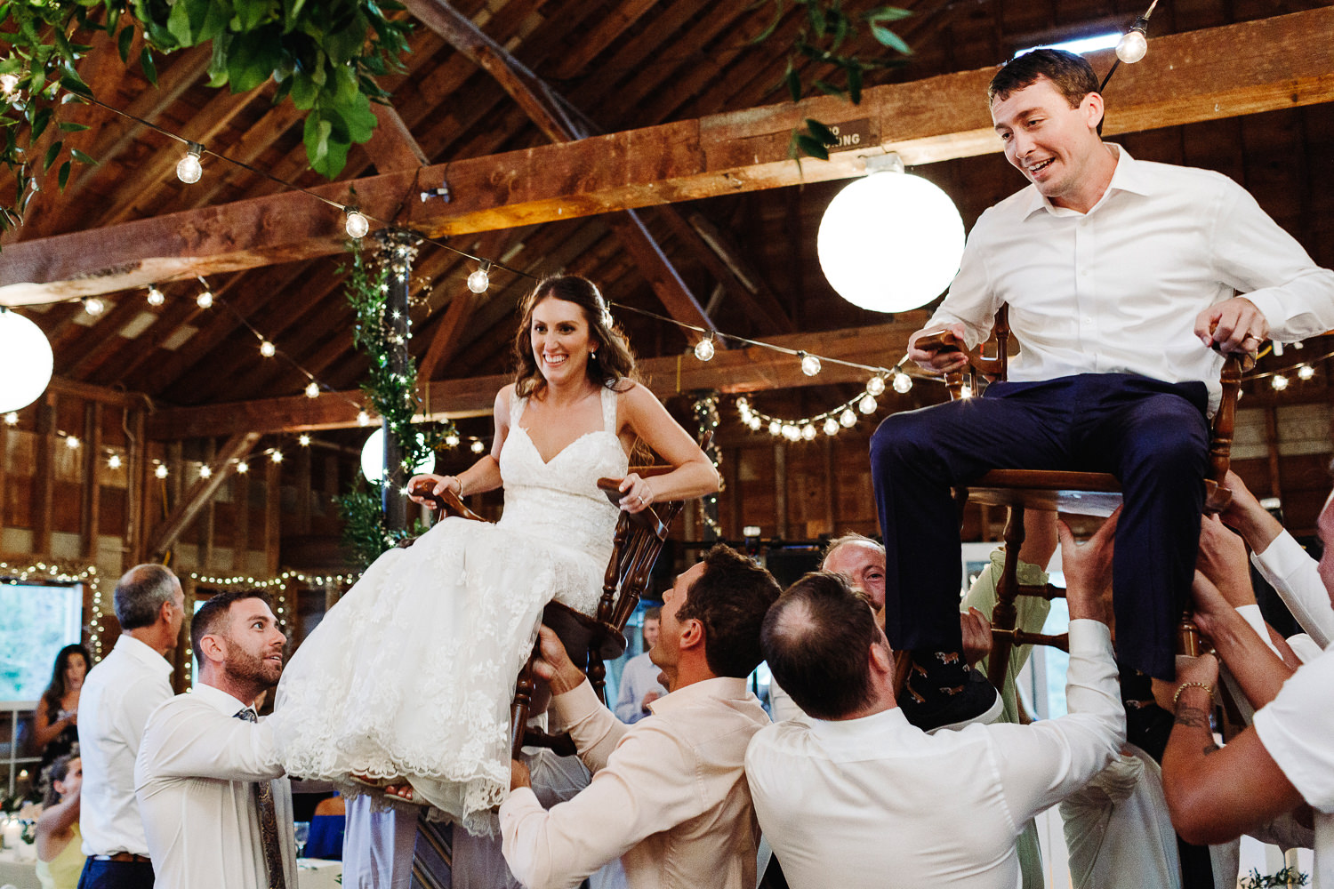 bride and groom on chairs during the hora at Arlington, Vermont wedding