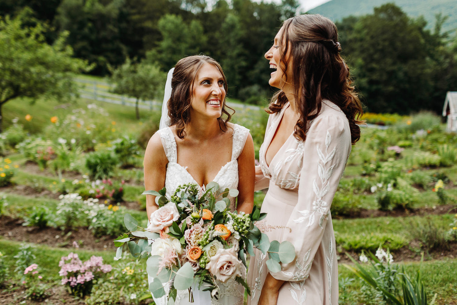 bride laughing with her sister at Arlington, Vermont wedding at West Mountain Inn