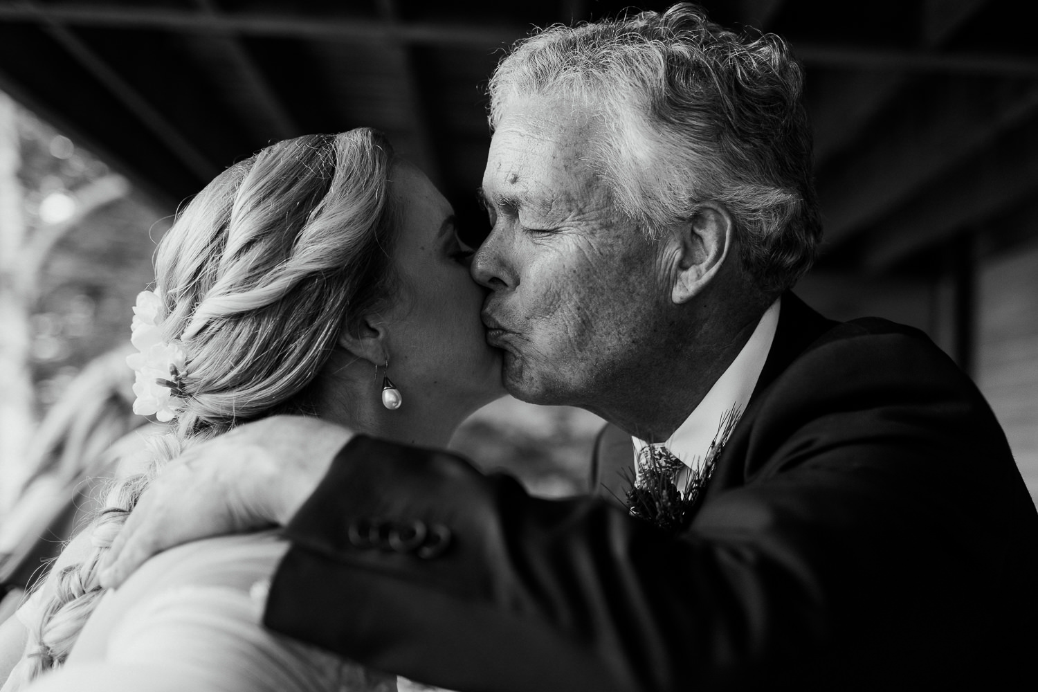 father of the bride kissing her cheek