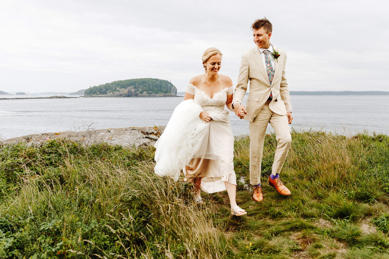 bride and groom walking hand-in-hand at August wedding in Bar Harbor