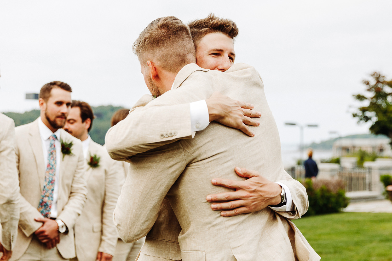 groom hugging his brother during wedding ceremony
