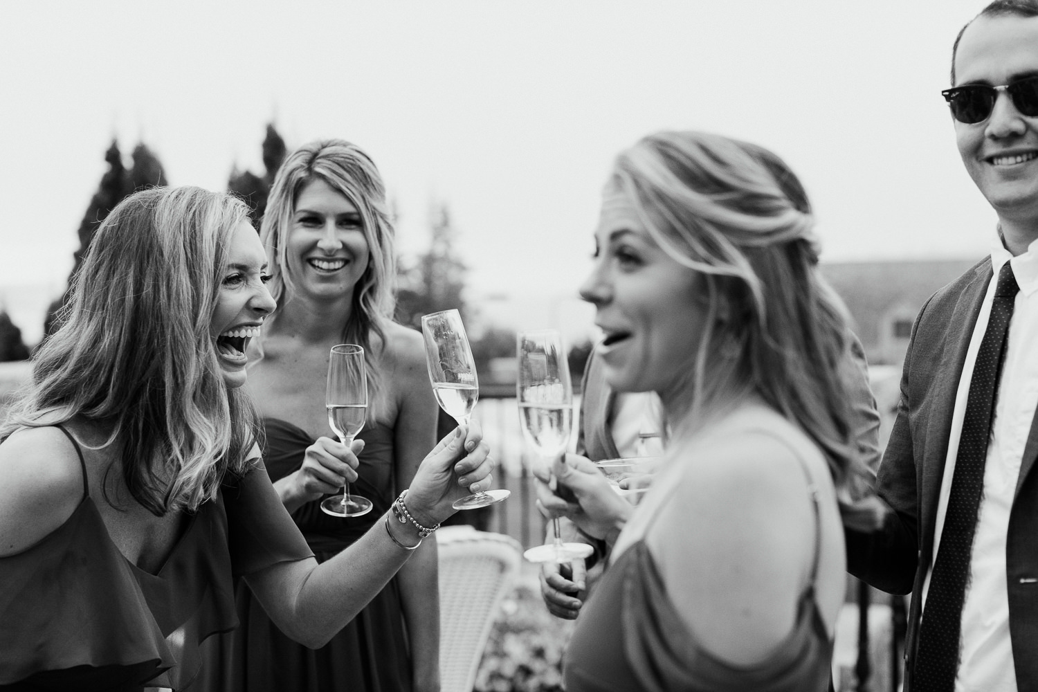 wedding guests laughing with champagne