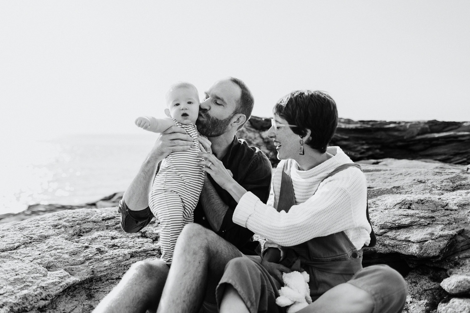 parents with their baby during summer portraits in Bristol, Maine