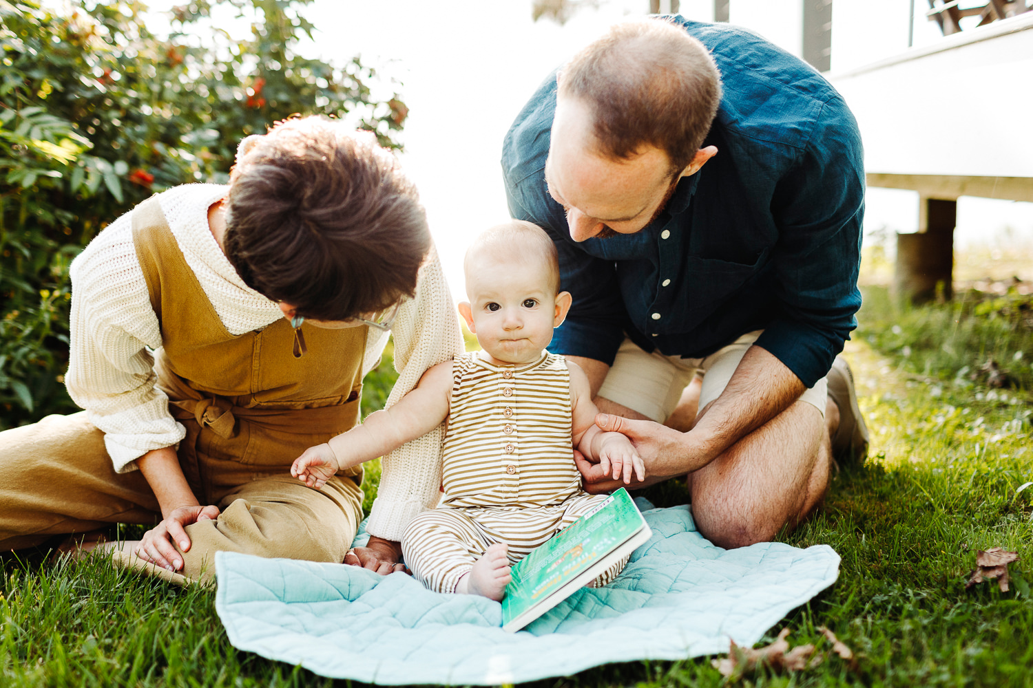parents reading to their baby 