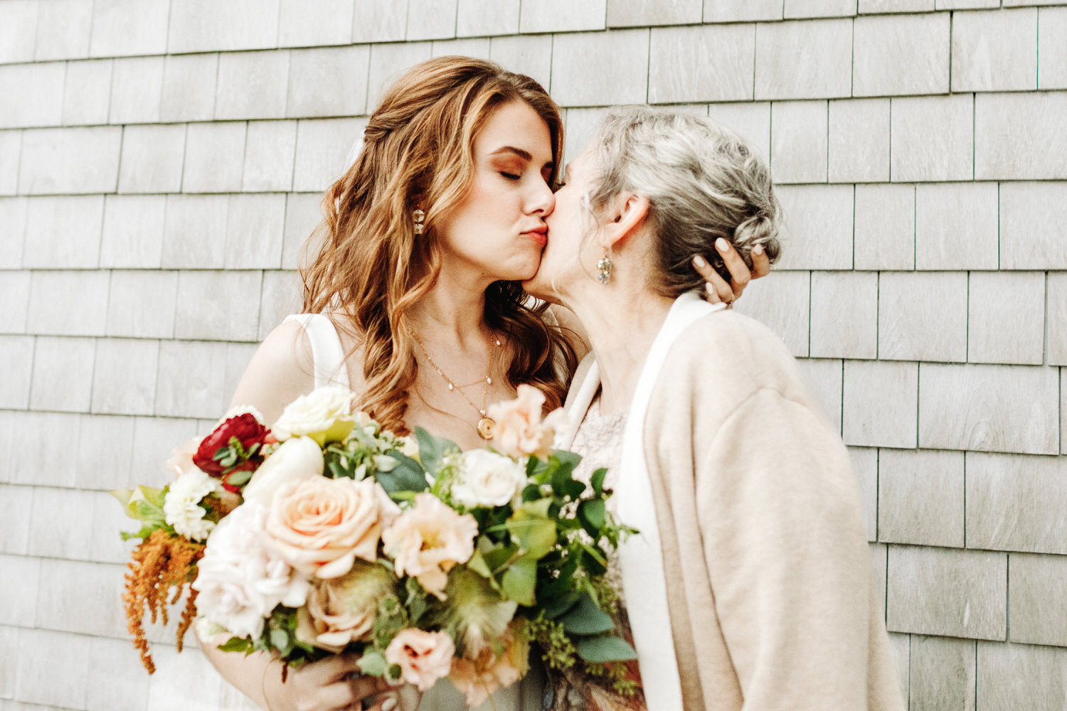 Bride kissing her mother's cheek