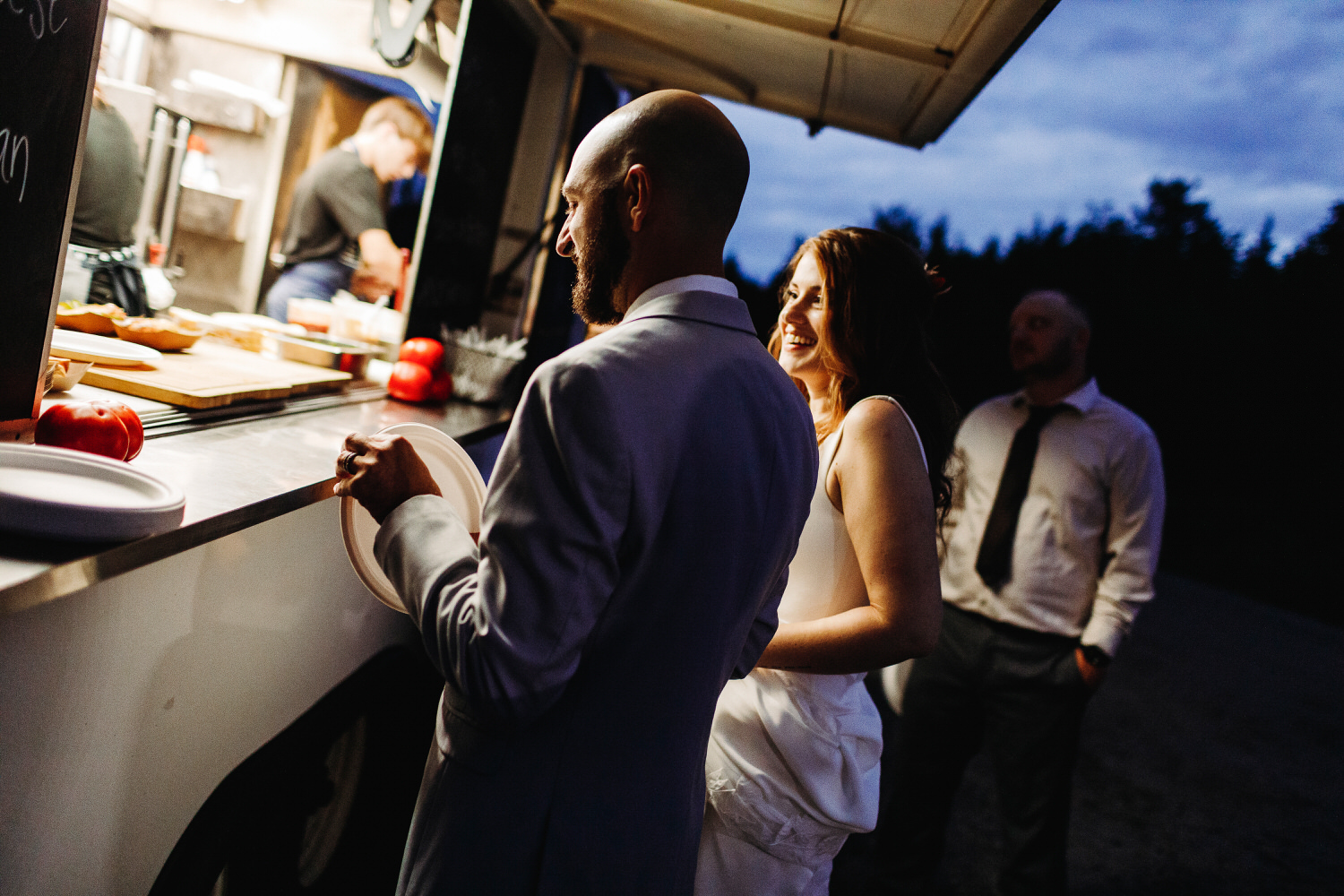 bride and groom getting food from food truck at Orr's Island Maine Wedding