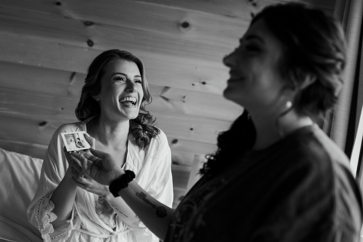 bride laughing with one of her bridesmaids