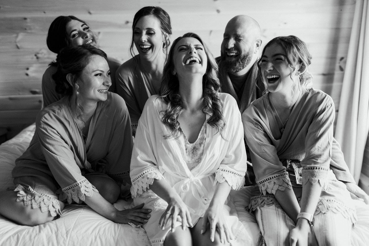 bride laughing with her bridal party