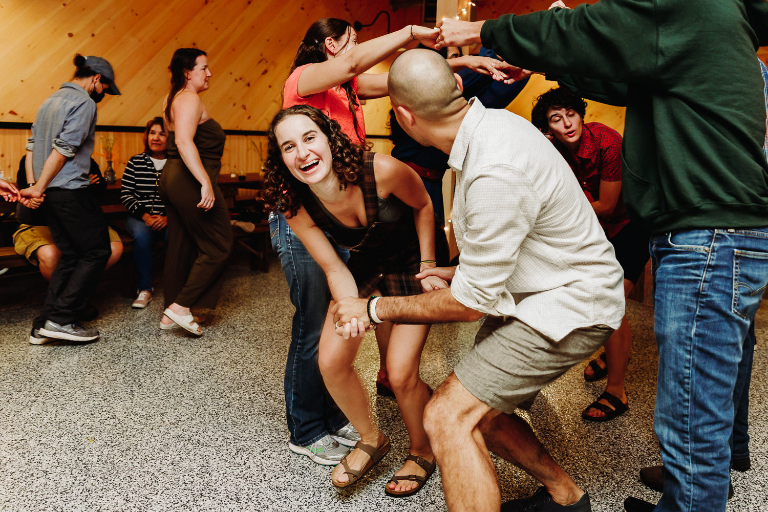 engaged couple contra dancing at their Maine wedding welcome party
