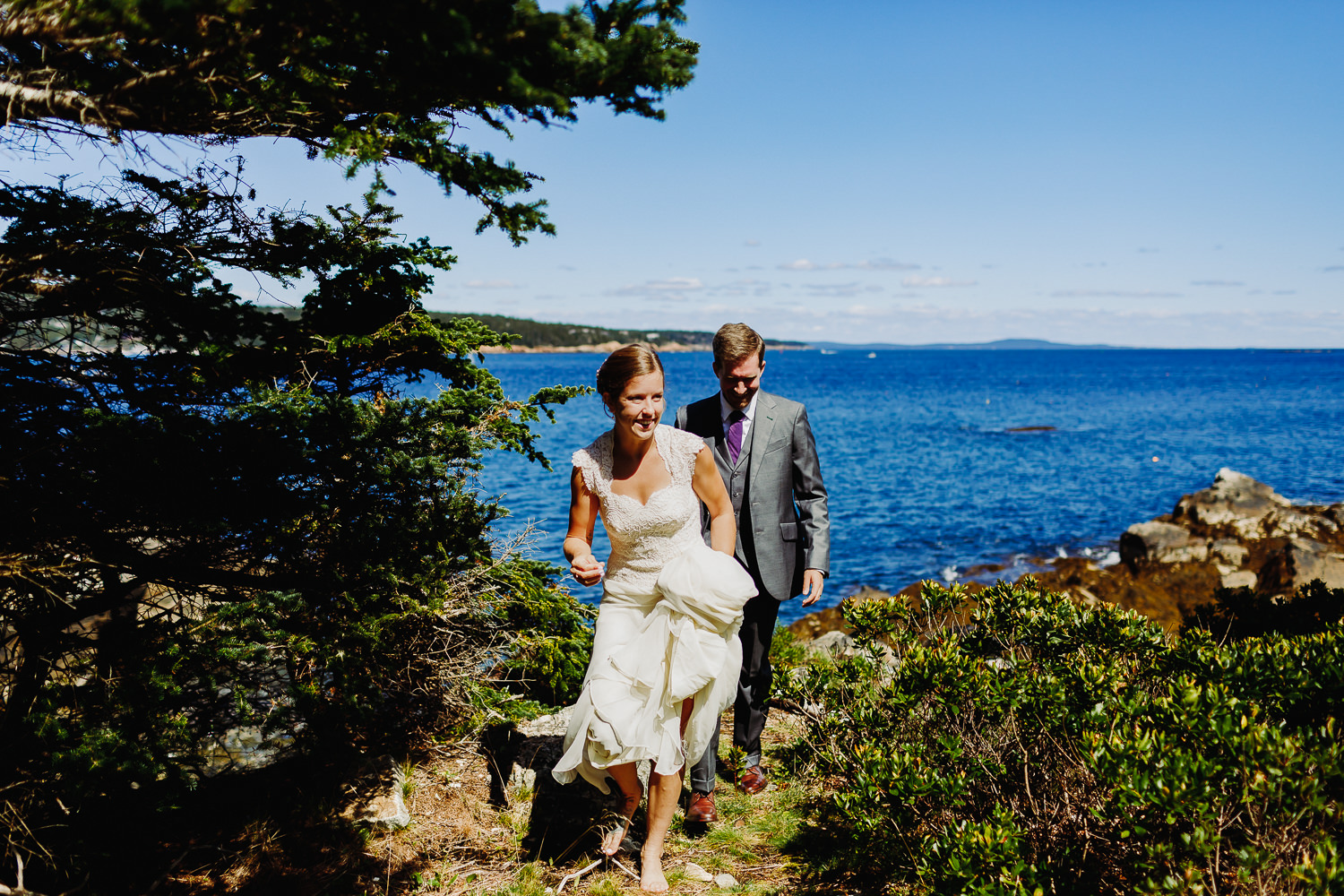 Bride and groom walking together on Sutton Island, Maine