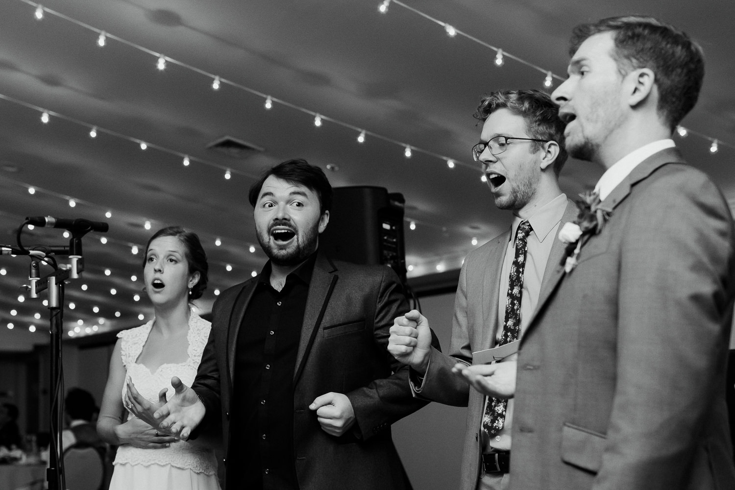 bride and groom singing with barbershop quartet at their wedding in Bar Harbor