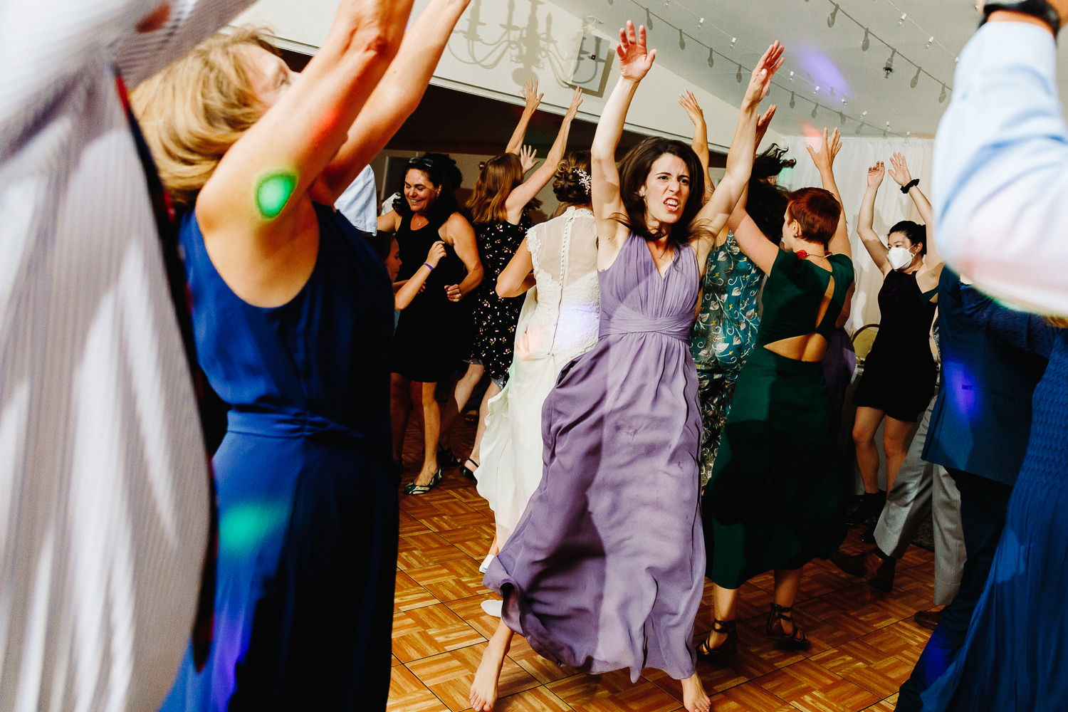 bridesmaid jumping as she dances at Sutton Island and Bar Harbor Maine Wedding