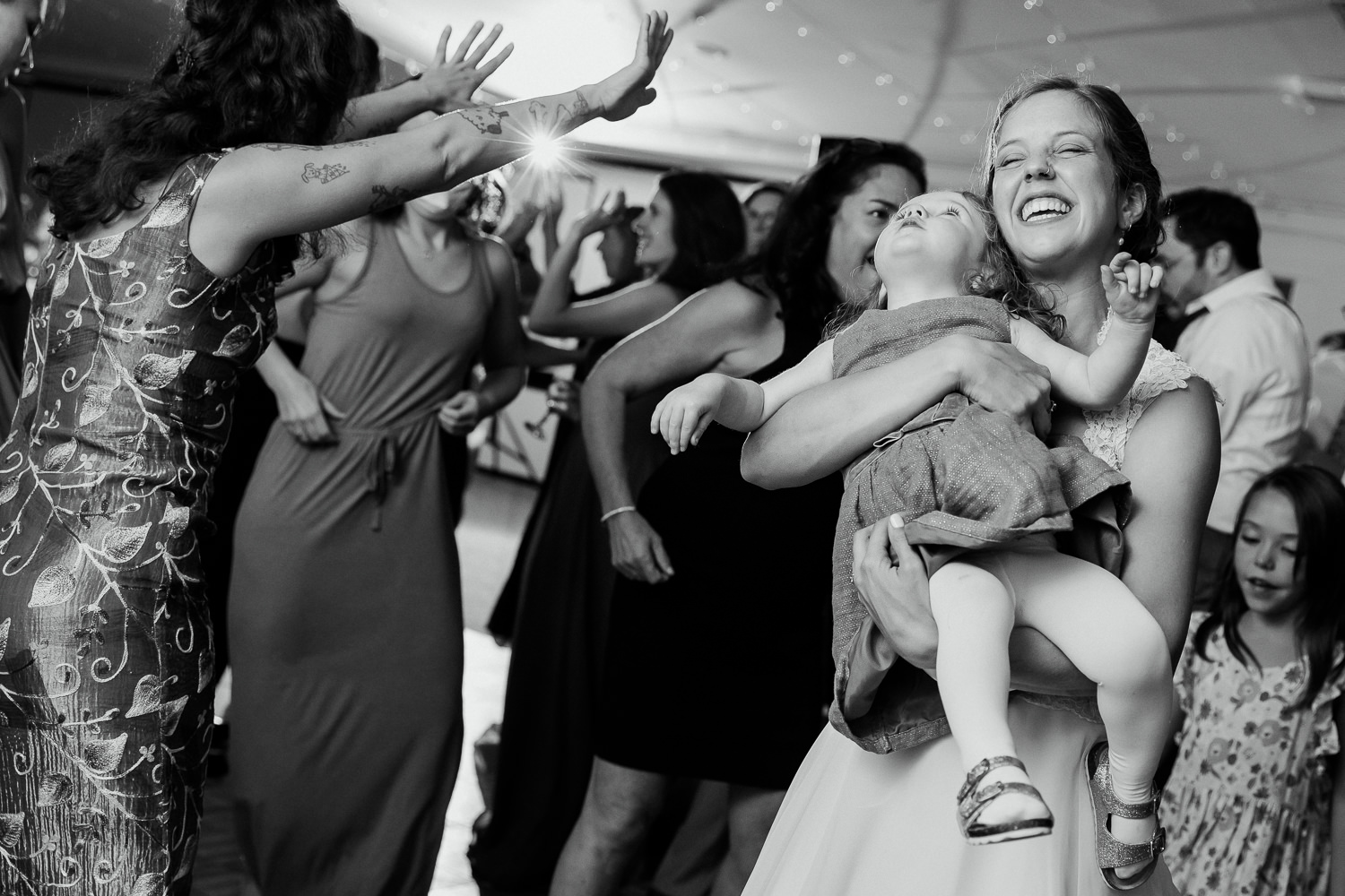 Bride dancing with flower girl at Sutton Island and Bar Harbor Maine Wedding