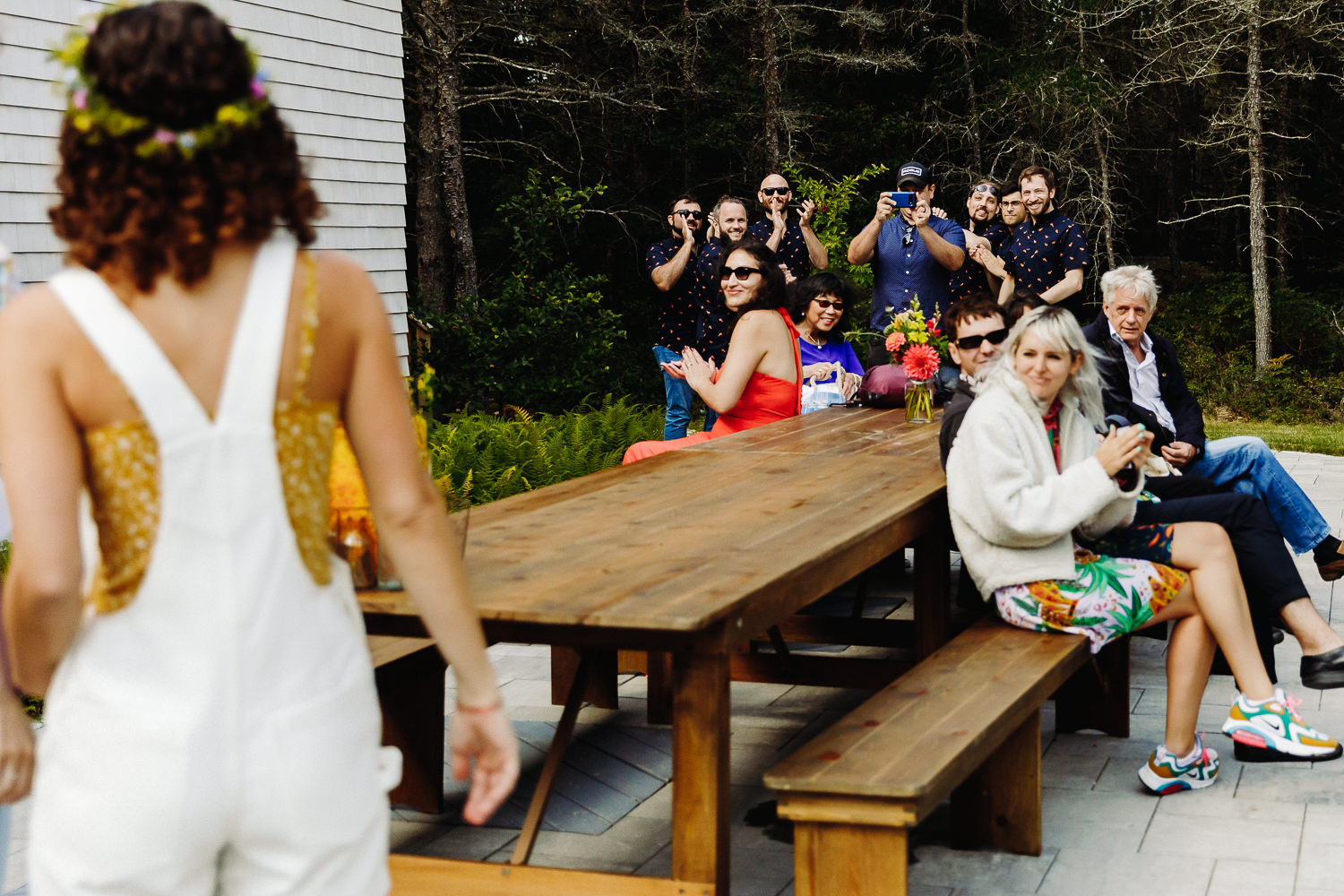 wedding guests clap as bride arrives to her Gouldsboro Maine campground wedding.