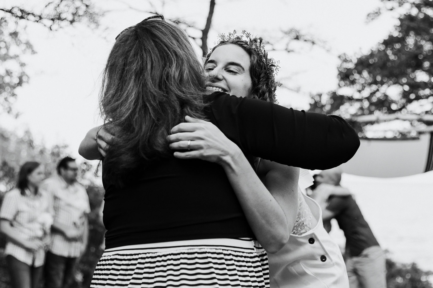 Bride hugs her mother at Gouldsboro Maine campground wedding.