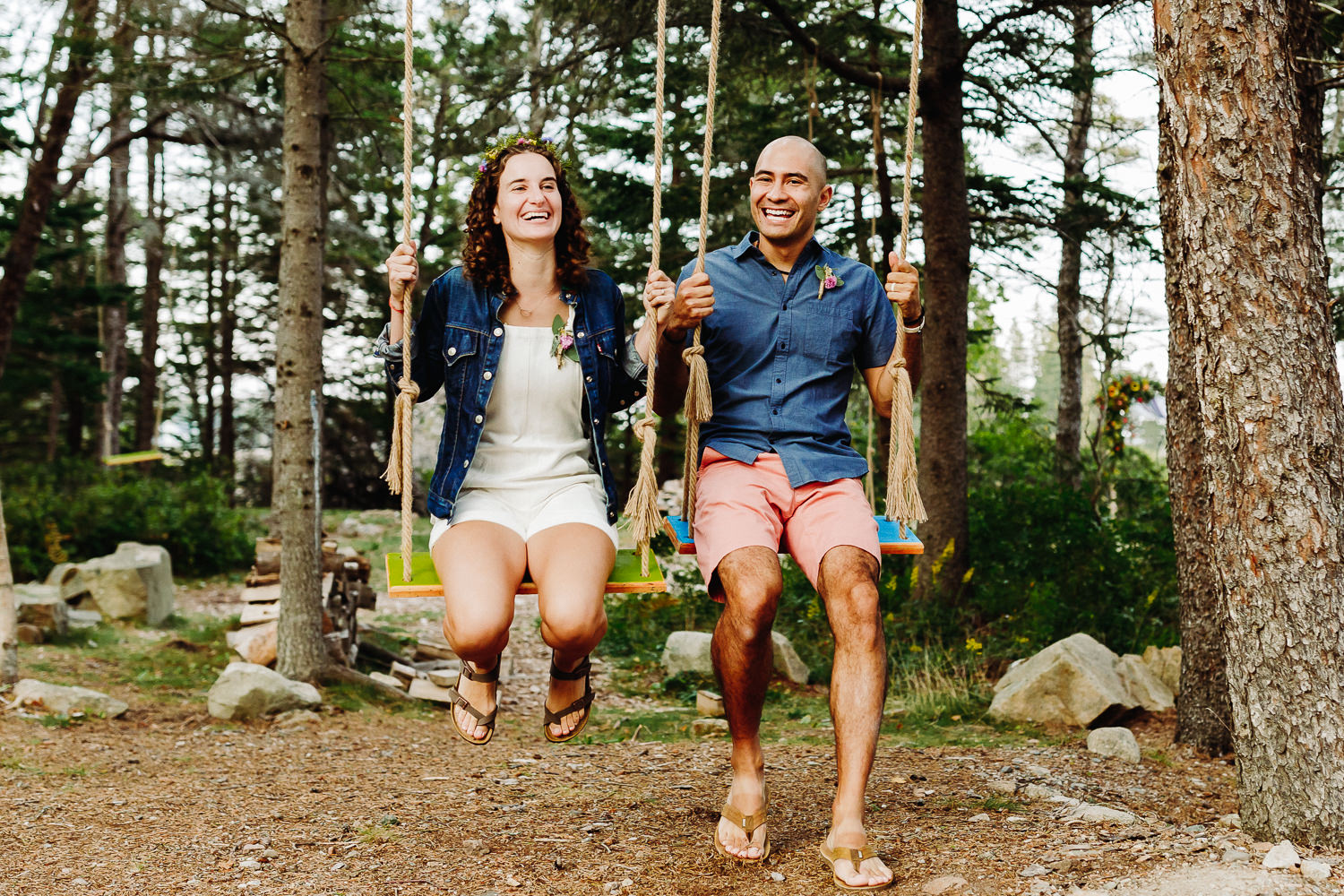 Bride and groom on swings during Gouldsboro Maine campground wedding.