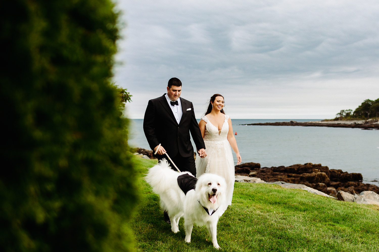bride and groom walking with their dog at Stage Neck Inn wedding in York Maine
