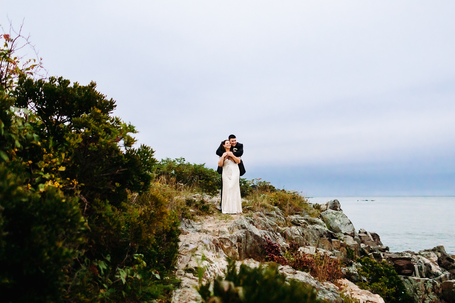 bride and groom on cliffs at Stage Neck Inn wedding in York Maine