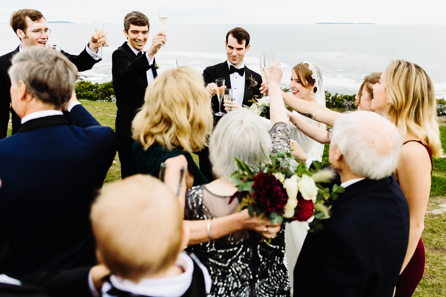 champagne toast at Pemaquid Point Lighthouse during Contented Sole Maine wedding