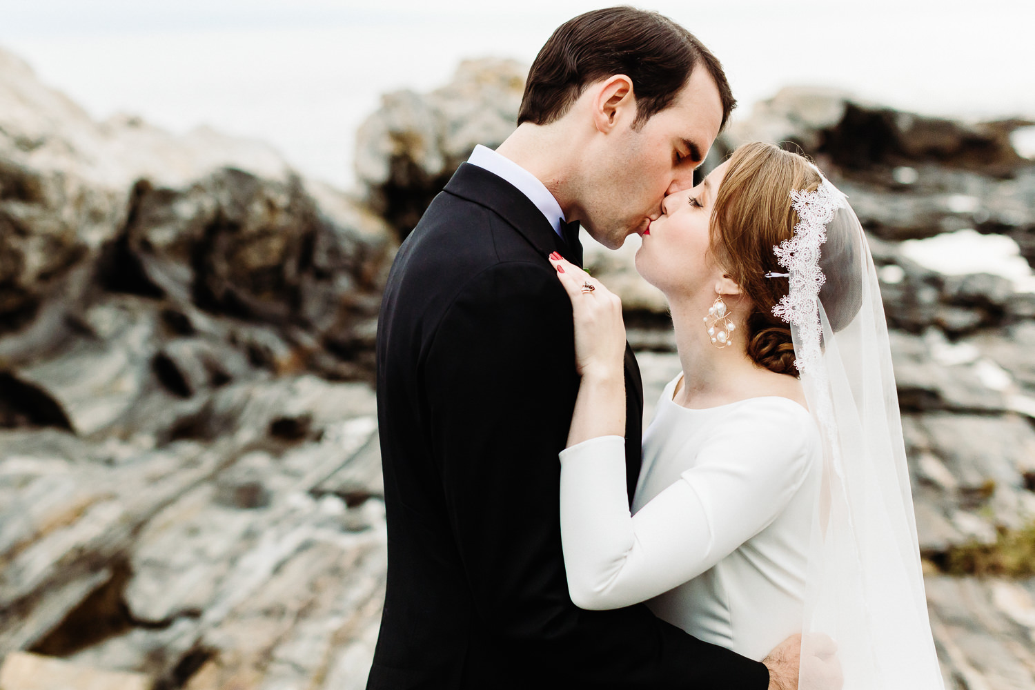 Bride and groom kissing at Pemaquid Point Lighthouse