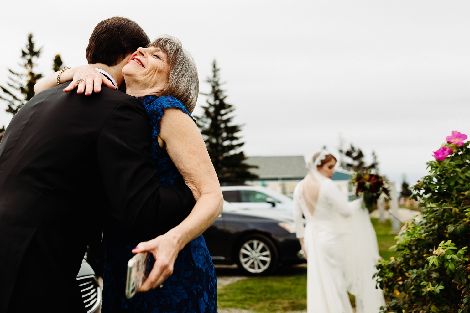 Groom hugging his mother during Contented Sole Maine wedding